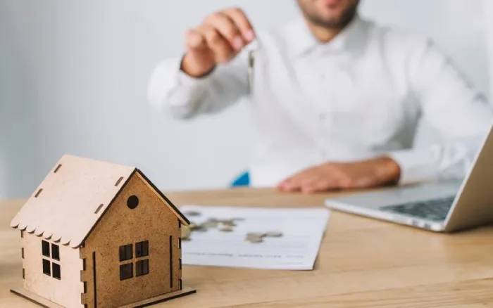 Happy family with new house keys - Home Loan Solutions by Sharanya Financial Consultancy